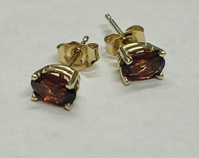 photo number one of 14 karat yellow gold 6x4 oval garnet stud earrings item 001-215-00916